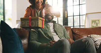 Buy stock photo Gift, surprise and couple in lounge, cover eyes and celebration for anniversary. House, woman and man on sofa, present and wow with gratitude, birthday and mature people with happiness and romance