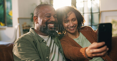 Buy stock photo Smile, couple and relax with selfie on sofa for photography, social media post or marriage commitment. Happy, African woman and mature man for profile picture update, love or loyalty together in home
