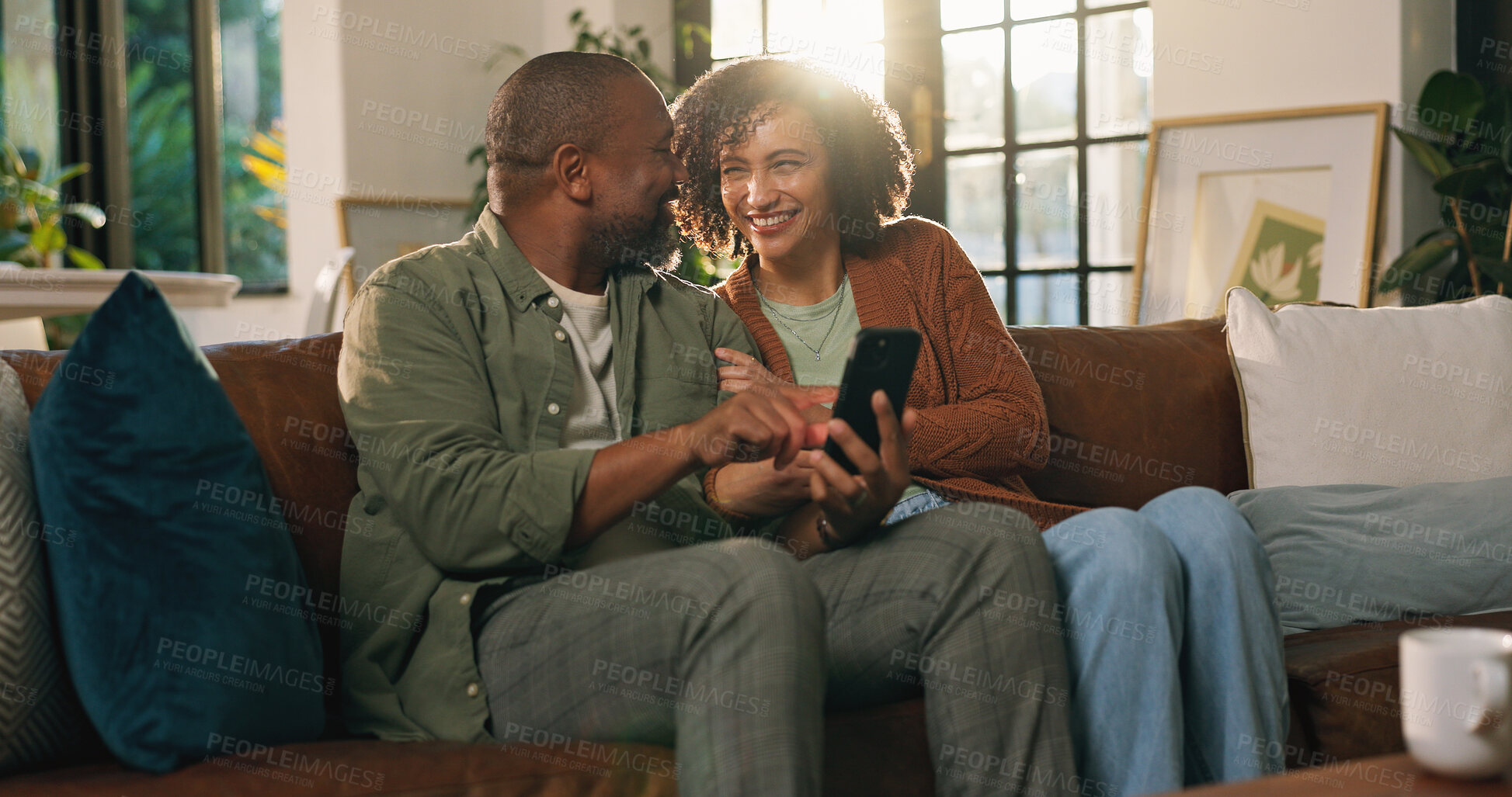 Buy stock photo House, conversation and couple on sofa, smartphone for social media and relax in living room. Apartment, man and woman on couch, cellphone and message to contact, internet and email notification