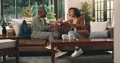 Buy stock photo Couple, fight and angry in lounge, talking or African people with bad communication and disagree. Home, mature man and argument with woman in living room, discussion and unhappy in toxic marriage