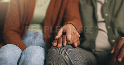 Buy stock photo Couple, holding hands and support with comfort on sofa for understanding or bonding in home. Closeup, man and woman with love, care or commitment for relationship, sympathy or trust together in house