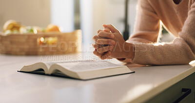 Buy stock photo Bible, prayer and hands of woman in home with comfort, support or religion for spirituality. Worship, trust and person with praying by holy book for reading gospel with gratitude or peace in house.