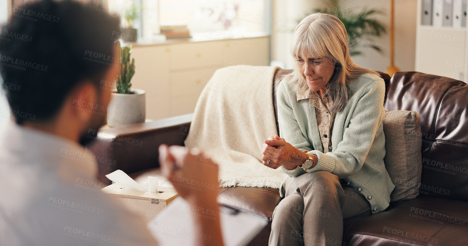 Buy stock photo Anxiety, patient or old woman in therapist office, mental health support or assessment for counselling. Psychologist, consultation or senior person nervous for evaluation, share trauma or talking