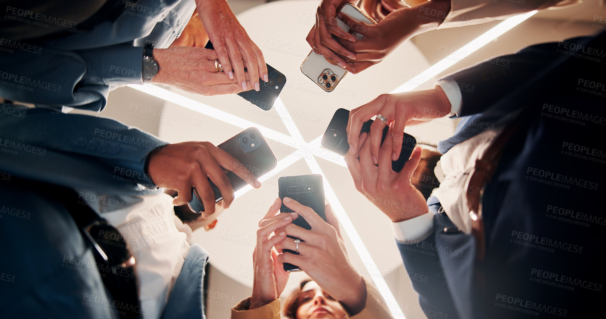 Buy stock photo Business people, hands and network with phone below for connection or data sync in office. Low angle, group or employees in circle with mobile smartphone for app share, user interaction or link