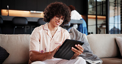 Buy stock photo Happy, man and relax with tablet at house for social media, streaming movies and weekend break. Smile, male person and digital for browsing website, download film and subscription service in lounge