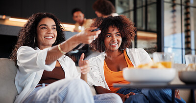 Buy stock photo Women, friends and watching tv on sofa with smile, remote control and movie choice in living room. People, happy and relax on couch with streaming, subscription or bonding with film in lounge at home