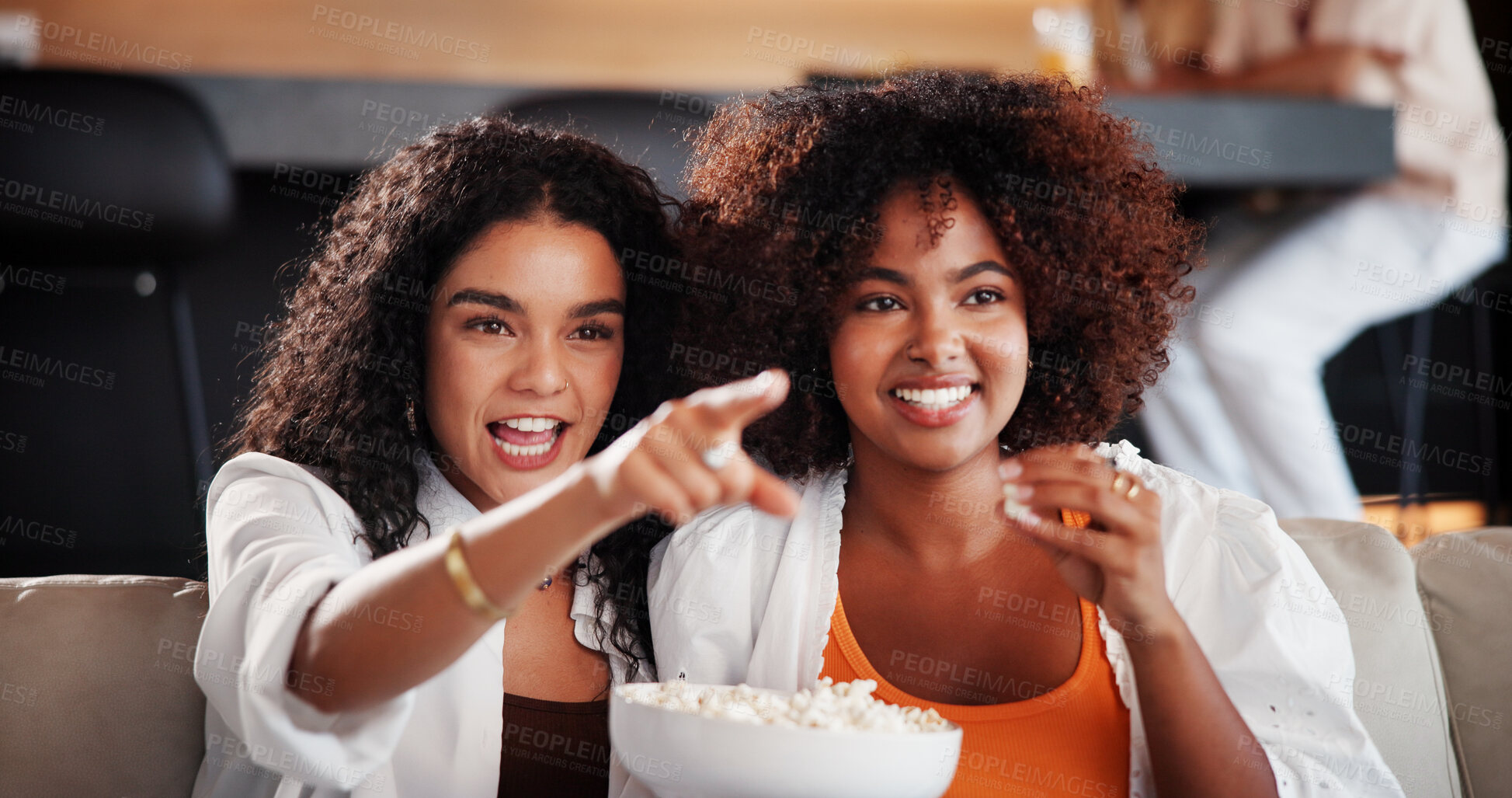 Buy stock photo Women, friends and watching tv with popcorn on couch, laugh or eating with funny movie in living room. People, happy and relax on sofa with streaming, bonding and film subscription in lounge at home