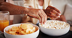 Hands, friends and popcorn in house for watching tv with movies, streaming service and relax in lounge. People. bowl and snacks with eating, hungry and drinks with film, bonding or television at home