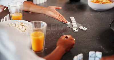 Buy stock photo Hands, friends and play dominoes in home with snacks, bonding and relax with contest on break. People, group and above with game, strategy and competition with drinks with reunion at apartment