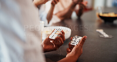 Buy stock photo Hands, group and game with dominoes in house with snacks, bonding and relax with challenge on break. People, friends and fun with play, strategy and competition with drinks for reunion at apartment