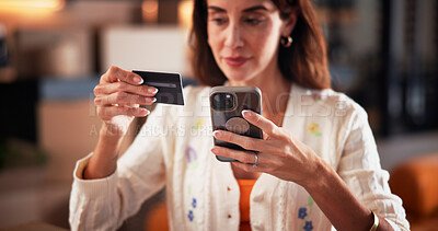 Buy stock photo Credit card, phone and woman in home for online shopping, subscription and digital purchase. Reading, ecommerce and person with bank info on smartphone for payment, transaction and sale on mobile app