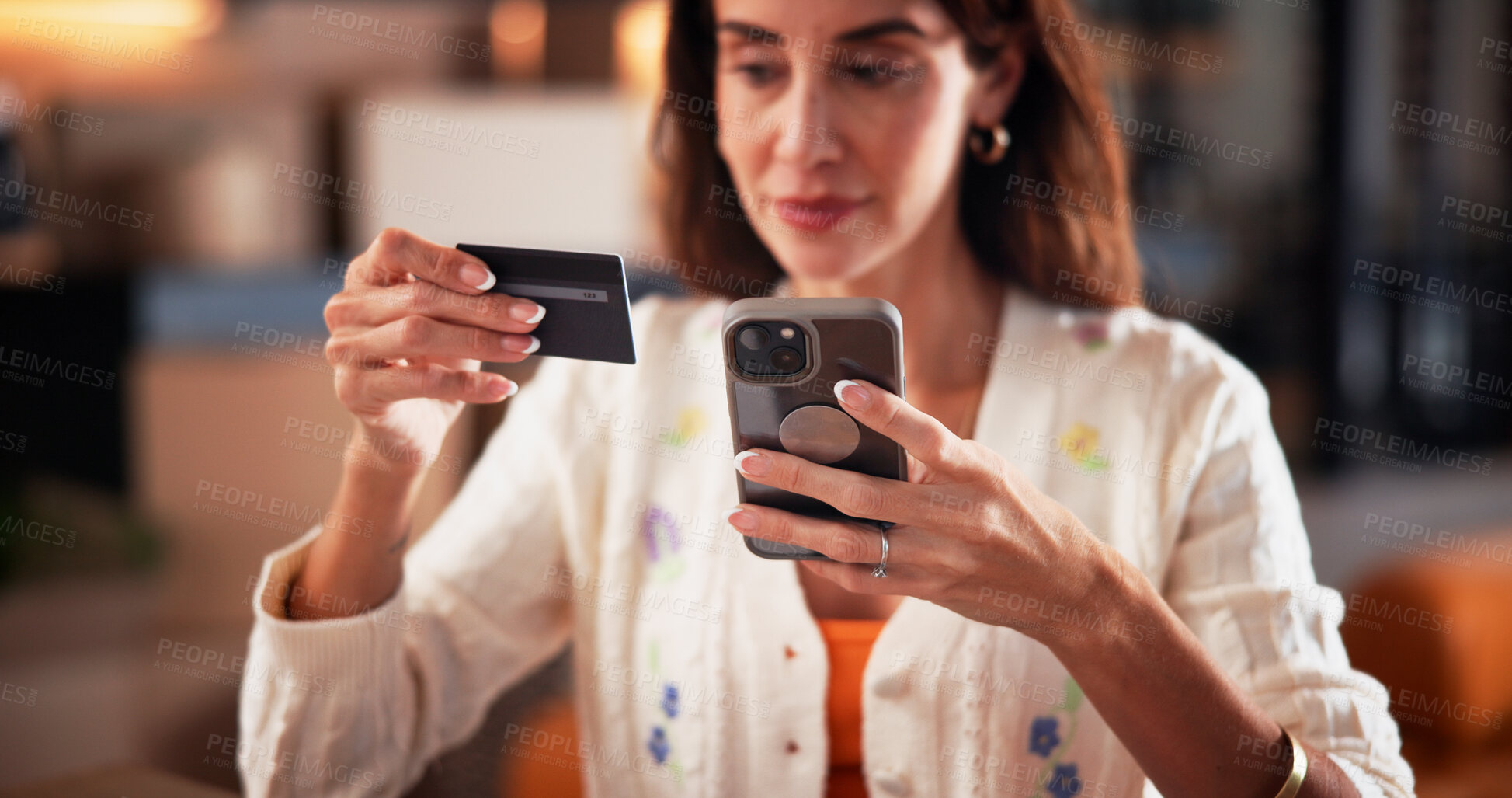 Buy stock photo Credit card, phone and woman in home for online shopping, subscription and digital purchase. Reading, ecommerce and person with bank info on smartphone for payment, transaction and sale on mobile app