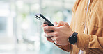 Phone, typing and hands of business man in office for social media, networking and online contact. Creative, startup and person on smartphone for communication, internet and email on mobile app