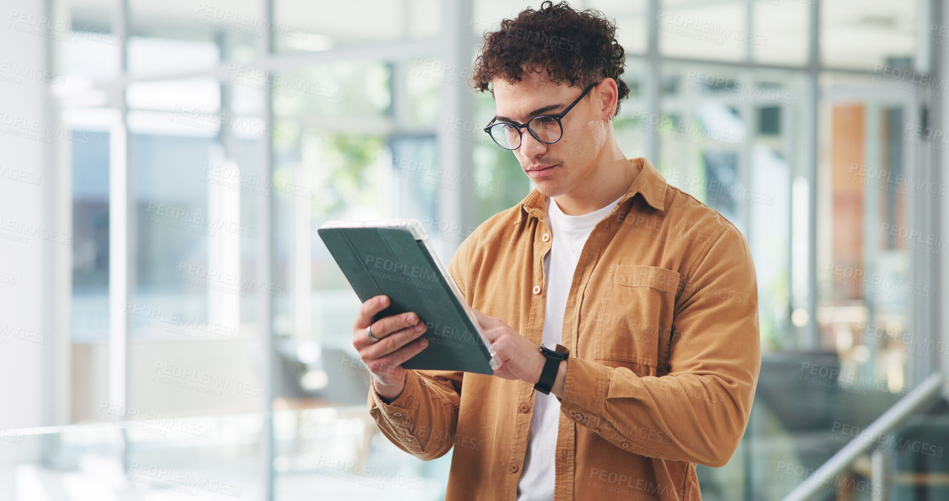 Buy stock photo Man, tablet and typing at startup with review, glasses or insight for project management at media company. Person, tech and scroll with app for proposal, feedback and check report at creative agency