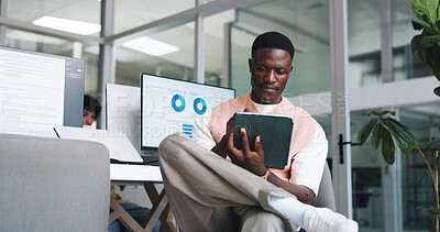 Buy stock photo Man, reading and research in office with tablet, data analysis and insight for performance marketing. Black person, coworking and tech in agency with planning, email and graphs for advertising stats.