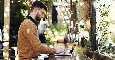 Buy stock photo Laptop, remote work and typing with businessman in coffee shop for small business research. Computer, planning and report with freelance employee at outdoor cafe or restaurant for startup development