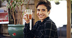 Portrait, woman and smile with alcohol at pub for happy hour, order and customer service. Confident, female person or glass with beer, cultural experience and whiskey beverage at hospitality industry