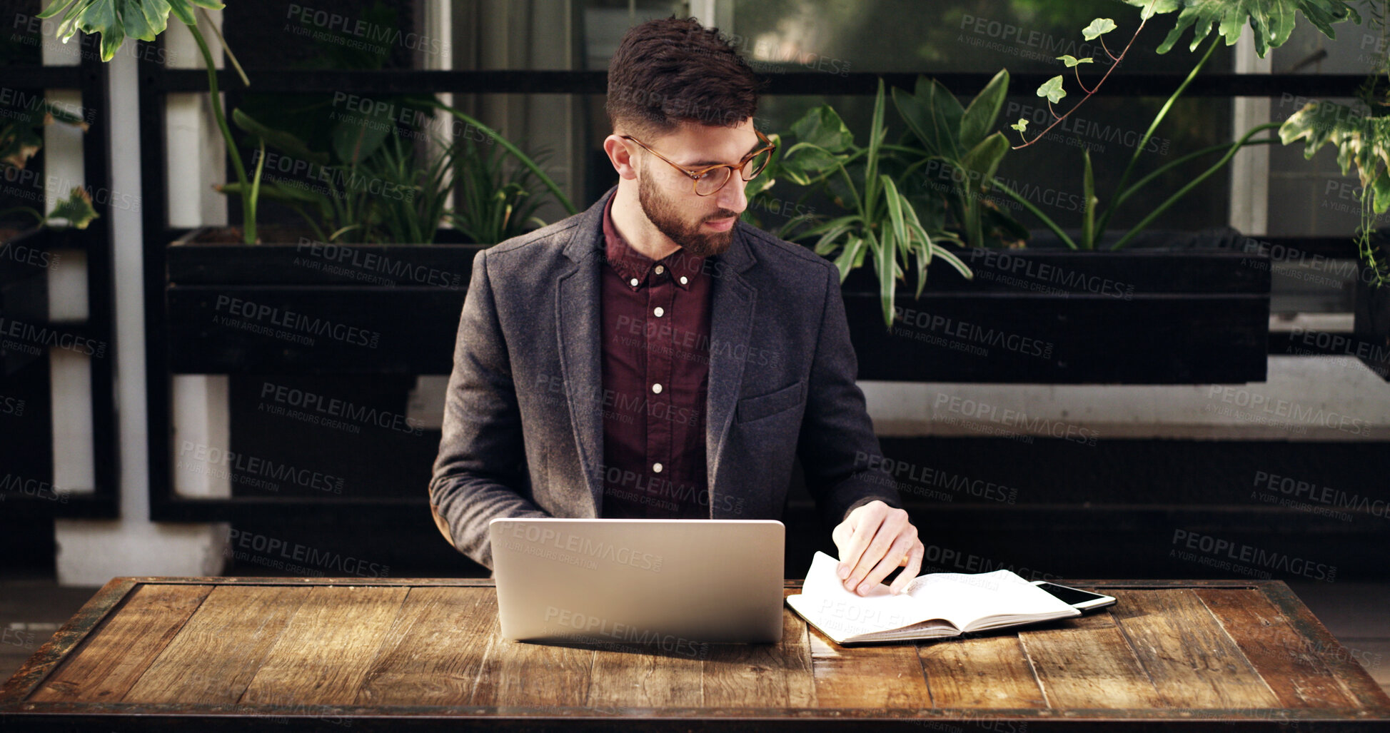 Buy stock photo Freelancer, notebook and man with laptop, cafe and planning for blog post with research or creative. Copywriter, reading and person with glasses for notes, remote work and ideas for project with tech