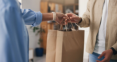 Buy stock photo Hands, paper bag and people in boutique, business owner and discount deal with purchase. Employee, consumer and customer in store, giving and retail for shopping spree, spending and checkout service