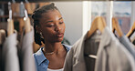 Decision, fashion and black woman in boutique for shopping, stylish clothes or thinking. African person, consumer or customer in store, luxury retail or options for fabric, promotion or discount deal