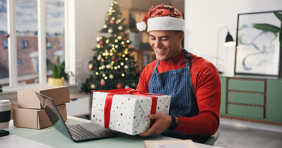 Buy stock photo Christmas, gift and smile with man in office for holiday celebration, startup and laptop. Festive season, present and dropshipping agency with employee and box for secret Santa and small business