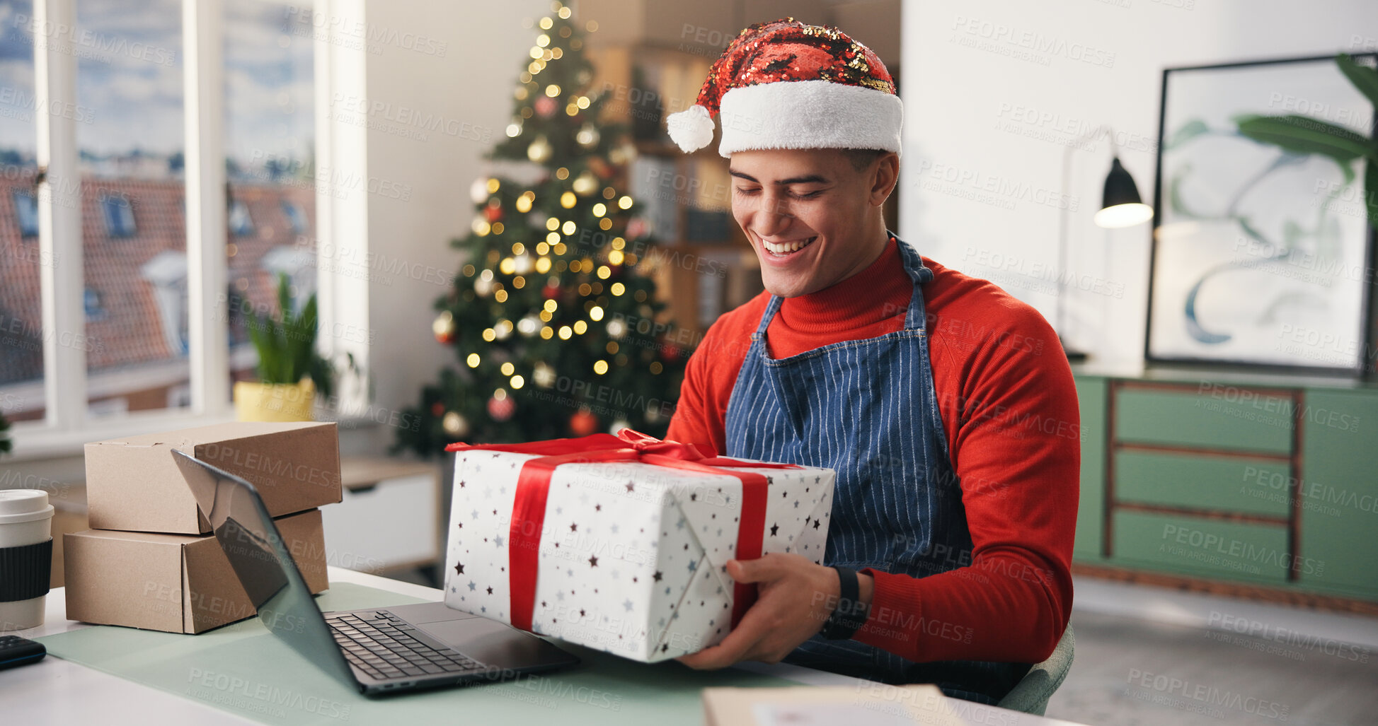 Buy stock photo Christmas, gift and smile with man in office for holiday celebration, startup and laptop. Festive season, present and dropshipping agency with employee and box for secret Santa and small business