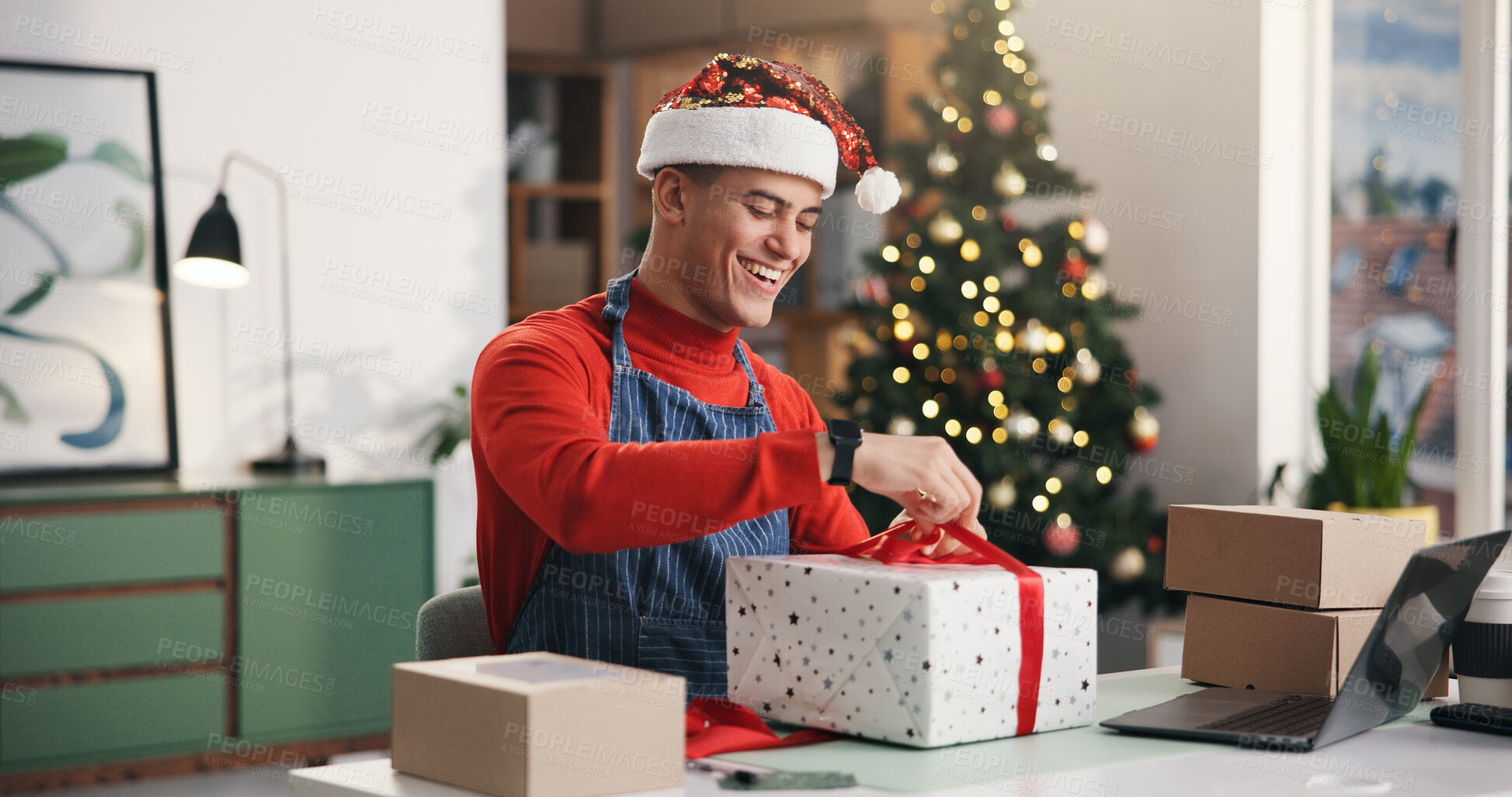 Buy stock photo Christmas, gift and wrapping with man in office for holiday celebration, startup and laptop. Festive season, present and dropshipping agency with employee and box for secret Santa and small business