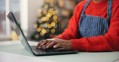 Buy stock photo Christmas, hands and laptop with woman at desk in home for festive planning or online shopping. Computer, holiday and winter tradition with person typing in apartment for gift or present search