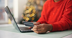 Person, hands and laptop with credit card for internet shopping, payment and Christmas in home. Shopper, bokeh or computer with debit for festive gift, online order or wireless transaction in house