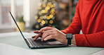 Christmas, hands and laptop with woman at table in home for festive planning or online research. Computer, gift search and winter tradition with person typing in apartment for holiday season