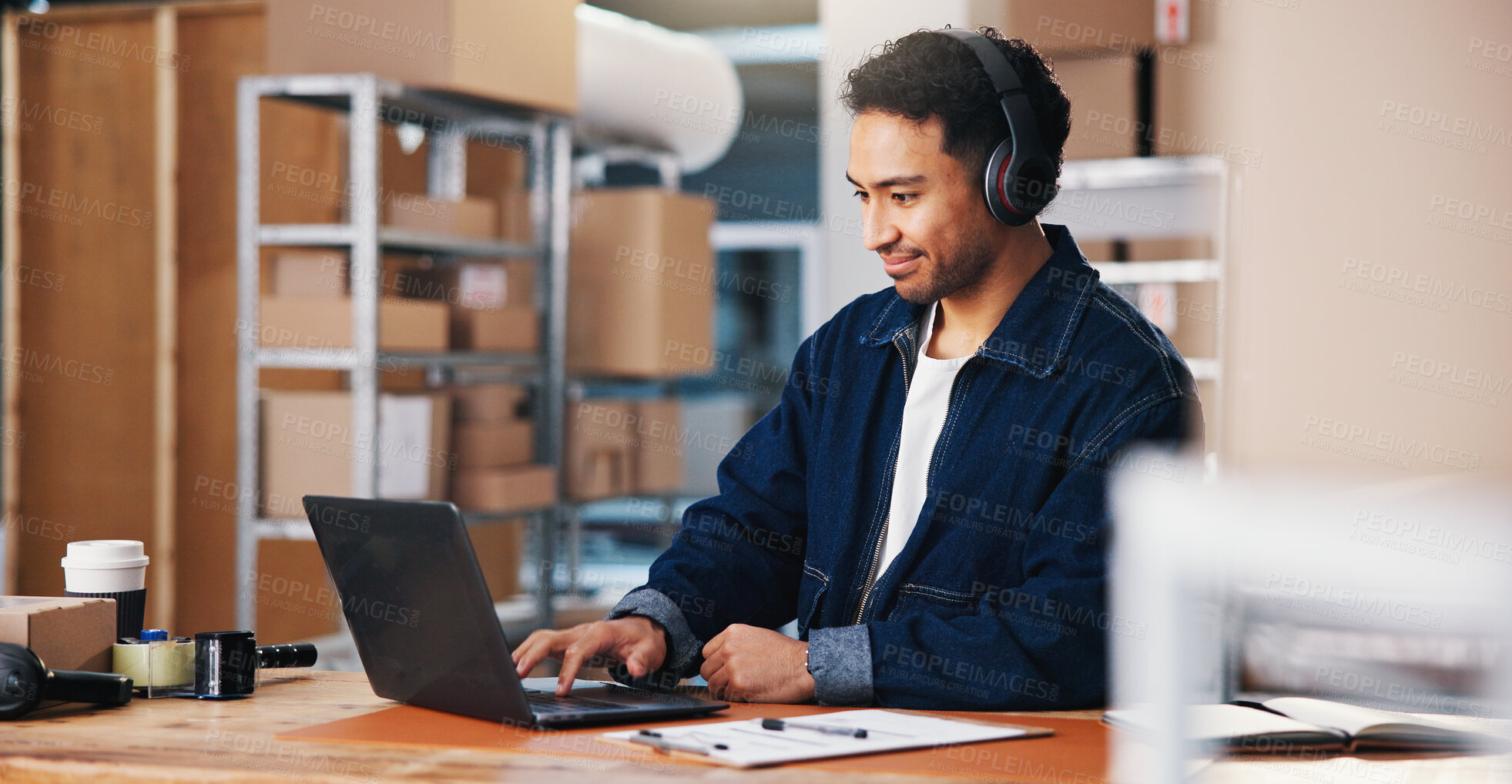 Buy stock photo Headphones, laptop and logistics with man in office for delivery schedule or storage management. Agenda, music and planning with employee person in courier workplace for supply chain business