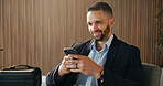 Business, luggage and man in airport, smartphone for online flight schedule and chatting. Person, trader and investor on chair, cellphone or email for visa application, smile or global trading deal