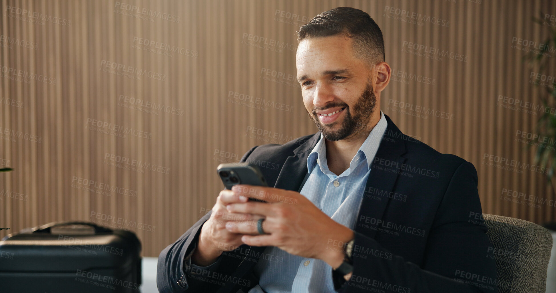 Buy stock photo Business, luggage and man in airport, smartphone for online flight schedule and chatting. Person, trader and investor on chair, cellphone or email for visa application, smile or global trading deal