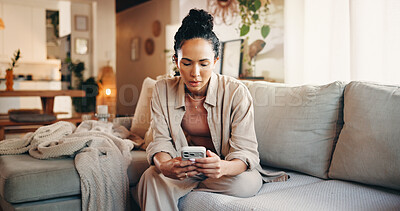 Buy stock photo Woman, scroll and reading in home with phone, text message notification or website for digital news. Female person, typing and browsing on sofa with tech, social media or mobile app for blog article.