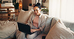 Woman, typing and research on sofa with laptop, remote work and website for digital marketing trend. Person, reading and browsing in home with computer, plan and freelance job for online advertising.