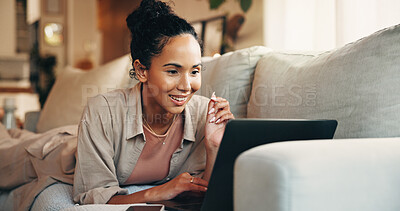 Buy stock photo Woman, smile and reading in home with laptop, remote work or good feedback for digital marketing idea. Happy, person and browsing on sofa with computer, freelance job or email for online advertising.