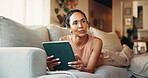 Relax, tablet and thinking with woman on sofa in living room of home for social media browsing. App, scrolling and vision with thoughtful person in apartment for break, me time chilling or wellness