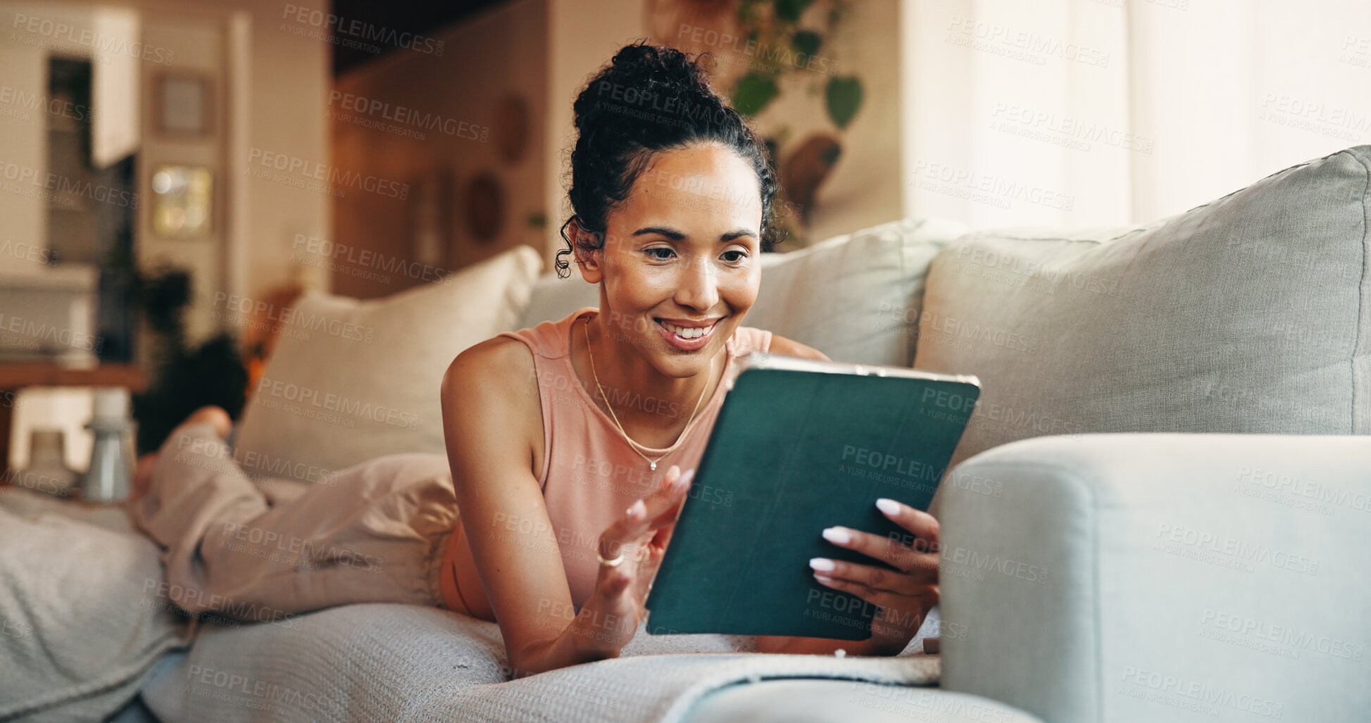 Buy stock photo Woman, relax and reading in home with tablet, text message notification and website for online news. Female person, smile and browsing on sofa with tech, social media or digital app for blog article.