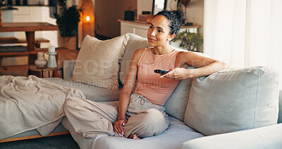Buy stock photo Woman, relax or watching tv on sofa with remote, streaming service or entertainment on weekend break. Female person, chill and change channel in home with tech, movie choice or subscription for film.