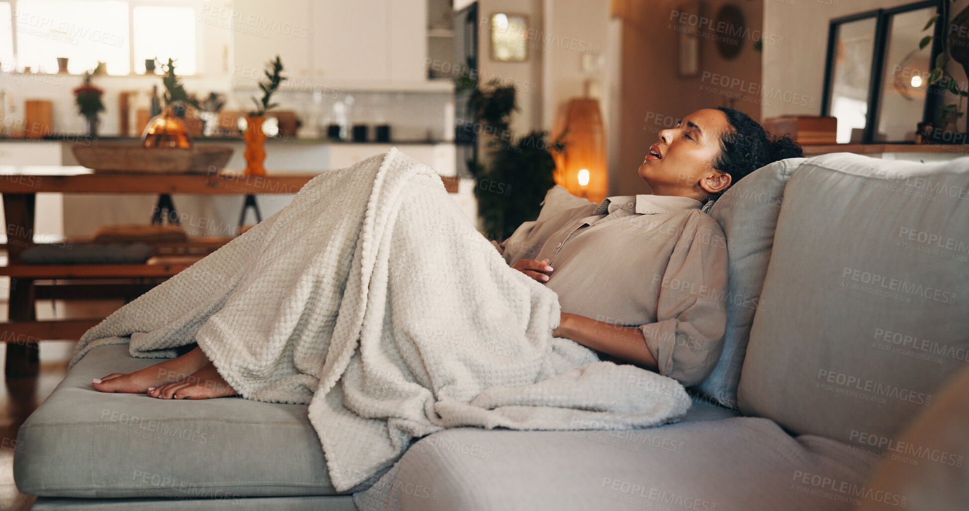 Buy stock photo Frustrated, woman and stomach ache with pain on sofa for indigestion or menstruation cycle in home. Female person, discomfort or sore tummy bug with period cramps, gastrointestinal reflux or diarrhea