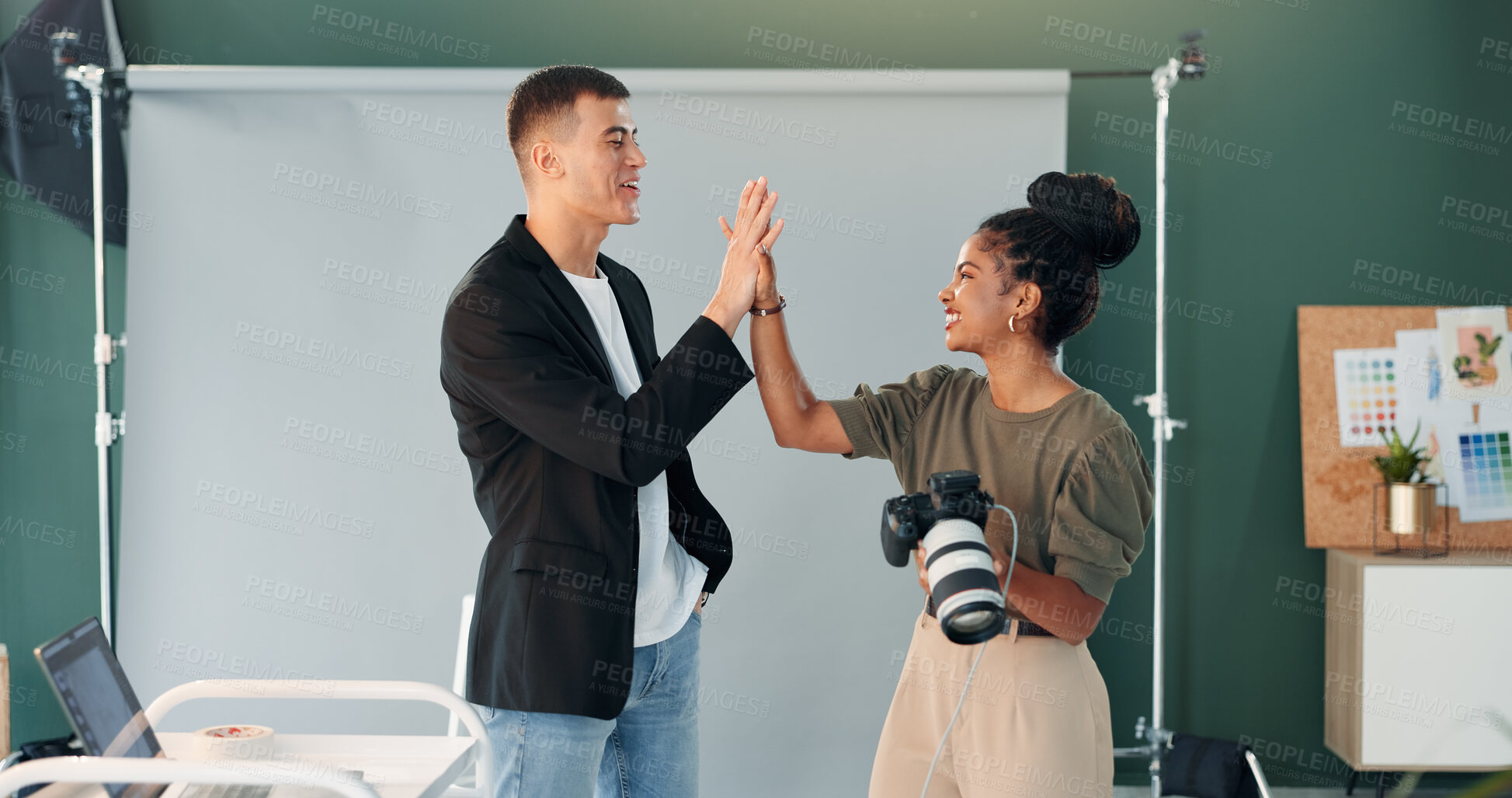 Buy stock photo Happy, photographer and model in studio with high five, camera and teamwork for production success. People, smile and celebration with photoshoot achievement, photography and creative collaboration.
