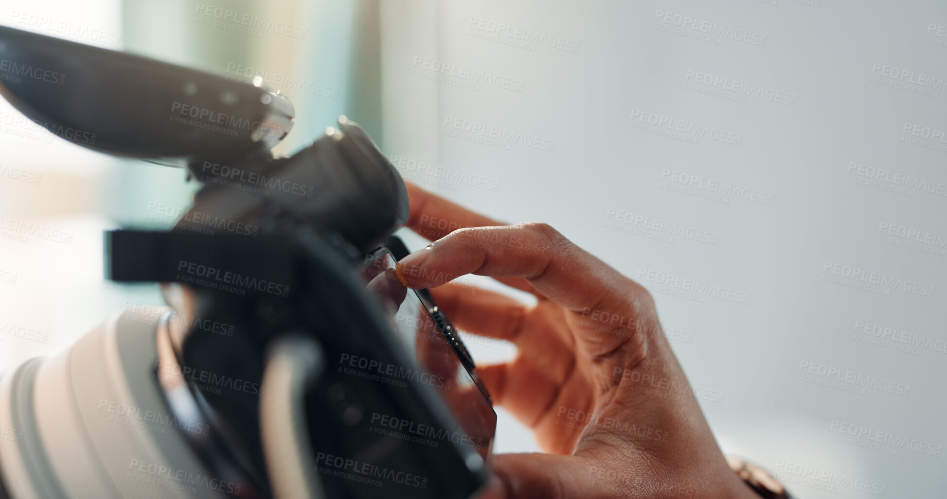 Buy stock photo Photographer, hand and camera screen in studio with review, photoshoot and film production results. Person, fingers and check with tech for photography, media project or change settings on equipment.