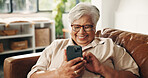 Laughing, phone and relax with old woman on sofa in home for retirement or social media. App, funny and scrolling with happy senior person in living room of apartment for browsing or communication
