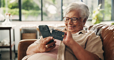 Buy stock photo Credit card, online shopping and phone with old woman on sofa in home for retirement as customer. App, ecommerce and smile with happy senior person in living room of apartment for payment or purchase