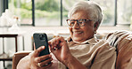 Laughing, phone and relax with senior woman on sofa in home for retirement or social media. App, funny and scrolling with happy old person in living room of apartment for browsing or communication