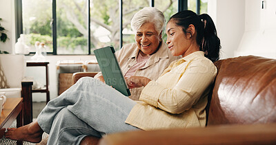 Buy stock photo Tablet, senior mother and daughter on couch, digital photo album and view nostalgic image for bonding. Smile, check social media and women with tech to watch family movie, browsing together and home