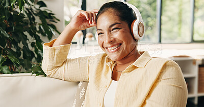 Buy stock photo Happy, woman and thinking in home with headphones, podcast and listening to music on weekend break. Mature person, smile and relax in living room with audio tech, online playlist and streaming radio.