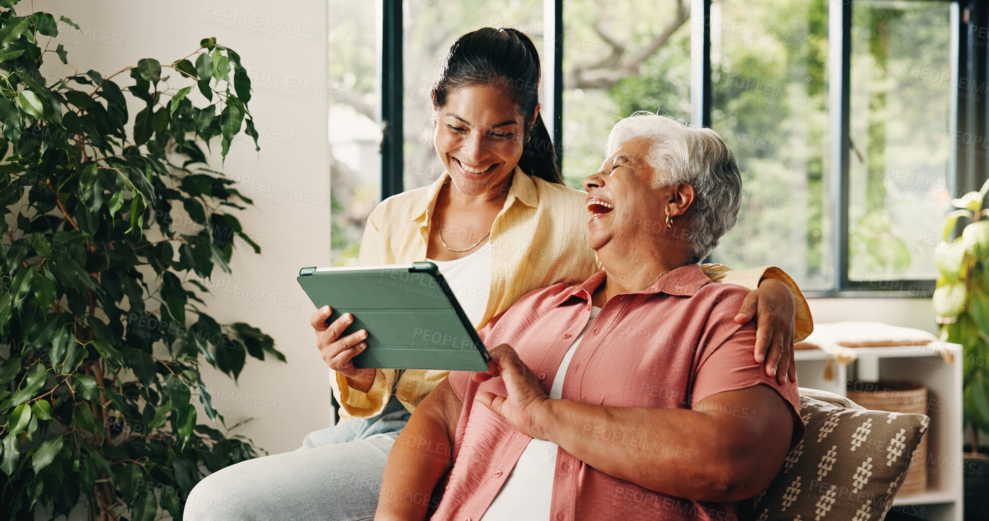 Buy stock photo Tablet, elderly mother and daughter on sofa, digital photo album and view funny image for bonding. Laugh, social media joke or happy women with tech to watch family movie, browsing or support in home