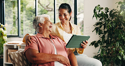 Buy stock photo Tablet, senior mother and daughter in home, digital photo album and view funny image for weekend bonding. Laugh, social media joke or happy women with tech to watch family movie, browsing or support 