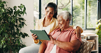 Buy stock photo Tablet, elderly mother or daughter on couch, digital photo album or view nostalgic image for bonding. Smile, social media memory or women with tech to watch family movie, browsing or support in home
